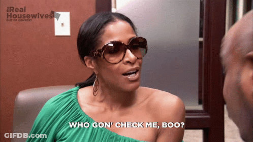 A Woman Wearing Sunglasses Says " Who Gon ' Check Me Boo " In Front Of A Real Housewives Logo GIF
