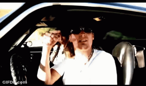 A Woman Wearing Sunglasses Sits In A Car GIF