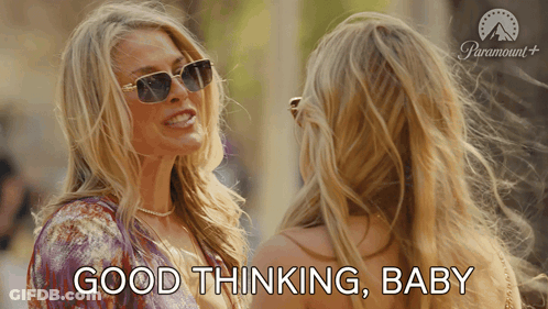 A Woman Wearing Sunglasses Talks To Another Woman And Says Good Thinking Baby GIF