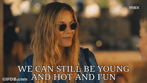A Woman Wearing Sunglasses With The Words We Can Still Be Young And Hot And Fun GIF