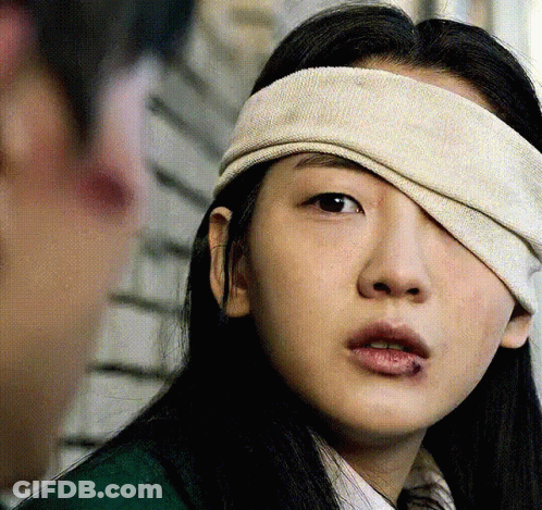 A Woman With A Bandage On Her Eye GIF