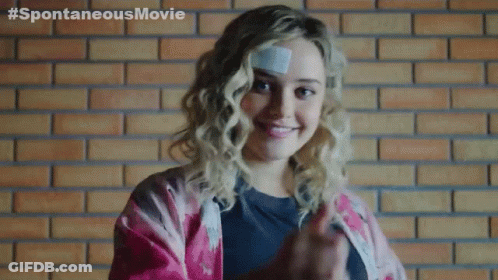 A Woman With A Bandage On Her Forehead Is Giving A Thumbs Up GIF