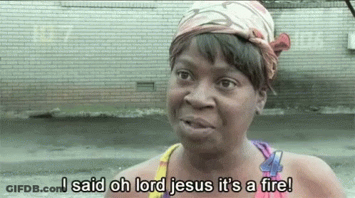A Woman With A Bandana On Her Head Is Saying I Said Oh Lord Jesus It 'S A Fire ! GIF