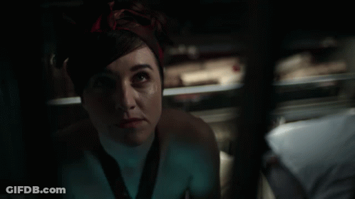 A Woman With A Bandana On Her Head Looks Up At Something GIF