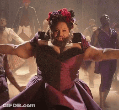 A Woman With A Beard In A Purple Dress Is Dancing GIF