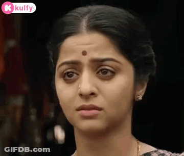 A Woman With A Bindi On Her Forehead Is Making A Funny Face . GIF