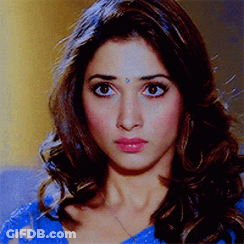 A Woman With A Bindi On Her Forehead Is Wearing A Blue Top GIF
