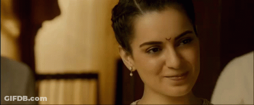 A Woman With A Bindi On Her Forehead Smiles GIF