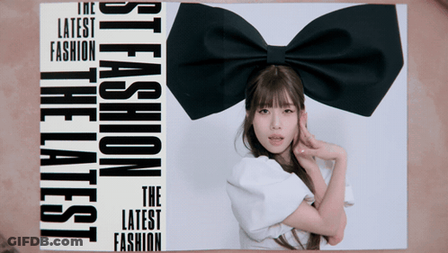 A Woman With A Black Bow On Her Head Is On The Cover Of A Magazine That Says The Latest Fashion GIF