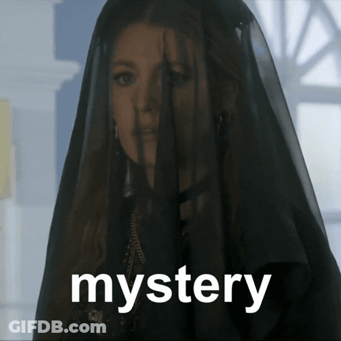 A Woman With A Black Veil On Her Head And The Word Mystery Below Her GIF