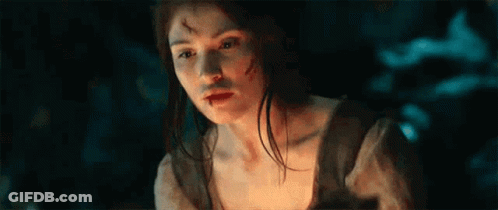 A Woman With A Bloody Face Is Holding A Torch In Her Hand . GIF