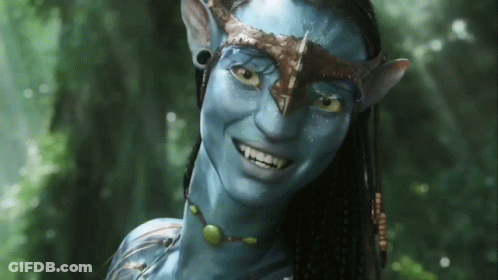 A Woman With A Blue Face And A Crown On Her Head Is Smiling GIF