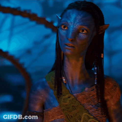A Woman With A Blue Face And Braided Hair Is Wearing A Scarf GIF