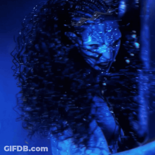A Woman With A Blue Face Is Screaming In The Water GIF