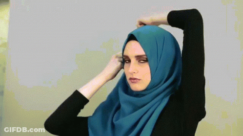 A Woman With A Blue Scarf Around Her Head GIF
