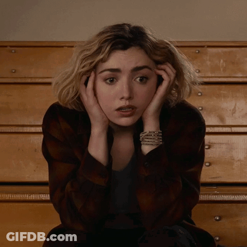 A Woman With A Bracelet On Her Wrist Covering Her Face GIF