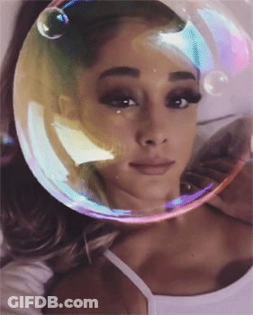 A Woman With A Bubble On Her Head Looks At The Camera GIF