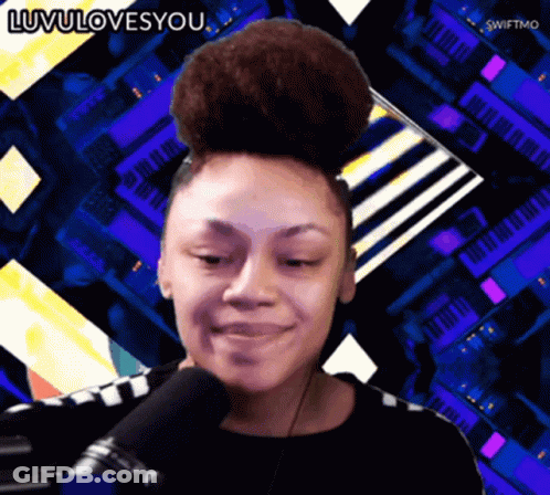 A Woman With A Bun On Her Head Is Smiling In Front Of A Microphone With The Words Luvulovesyou Below Her GIF
