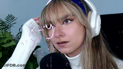 A Woman With A Cast On Her Hand Is Wearing Headphones GIF
