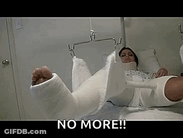 A Woman With A Cast On Her Leg Is Laying On A Bed . GIF