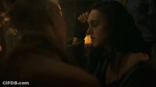 A Woman With A Choker Around Her Neck Is Looking At Another Woman GIF