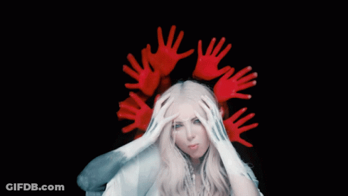 A Woman With A Crown Of Red Hands Covering Her Head GIF