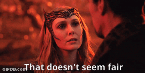 A Woman With A Crown On Her Head Is Looking At A Man With The Words That Does N't Seem Fair Below Her GIF
