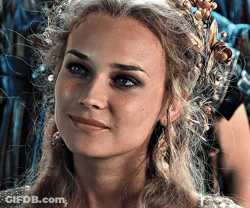 A Woman With A Crown On Her Head Looks At The Camera GIF