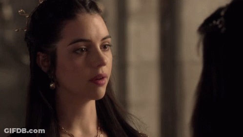A Woman With A Crown On Her Head Looks To The Side GIF