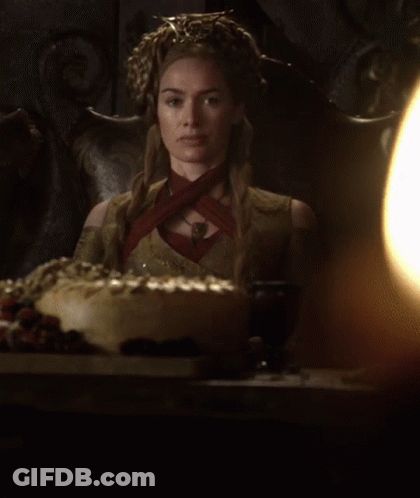 A Woman With A Crown On Her Head Sits In A Chair GIF