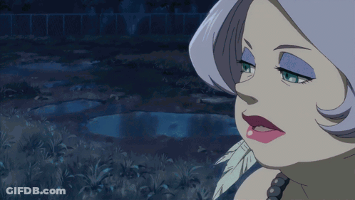 A Woman With A Feather In Her Mouth Is Making A Funny Face GIF