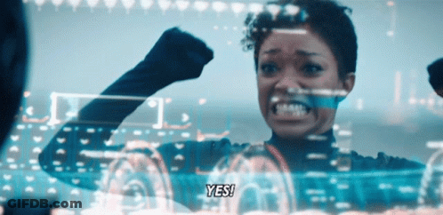 A Woman With A Fist Up Says Yes GIF