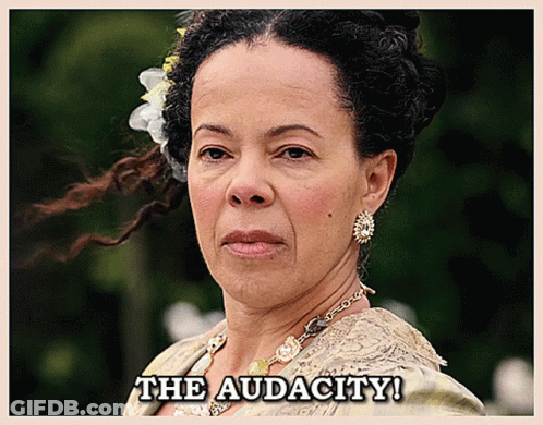 A Woman With A Flower In Her Hair And The Words The Audacity Below Her GIF