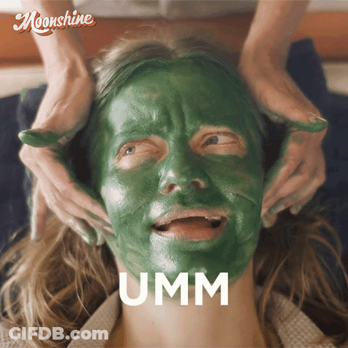 A Woman With A Green Mask On Her Face Has The Word Umm Above Her Face GIF
