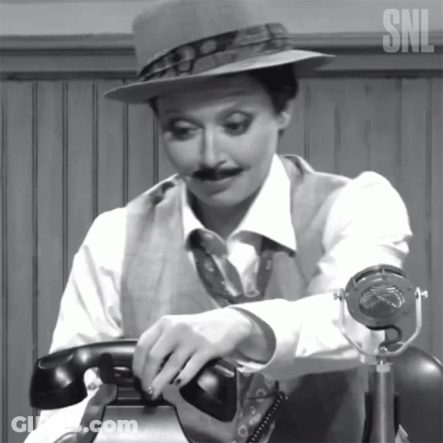 A Woman With A Hat And Mustache Is Talking On A Telephone With The Snl Logo In The Corner GIF