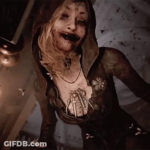 A Woman With A Hood And A Necklace With A Spider On Her Chest GIF