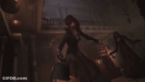 A Woman With A Hood And Keys On Her Chest Smiles GIF