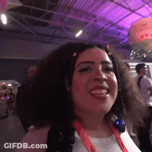 A Woman With A Lanyard Around Her Neck That Says ' Nintendo ' GIF