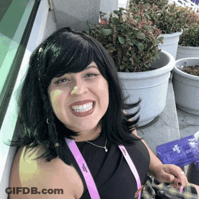 A Woman With A Lanyard Around Her Neck That Says ' Women 'S Alliance ' On It GIF