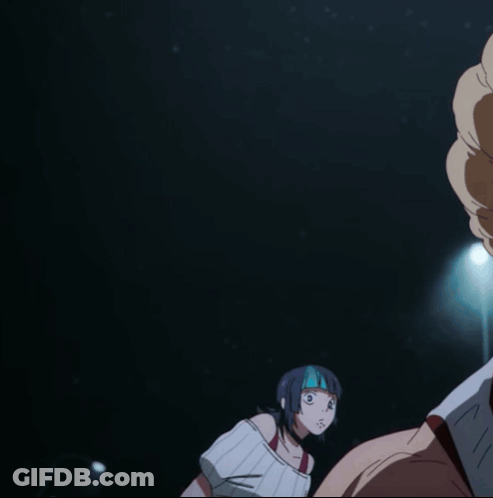 A Woman With A Mask On Her Face Looks At A Man In A Dark Room GIF