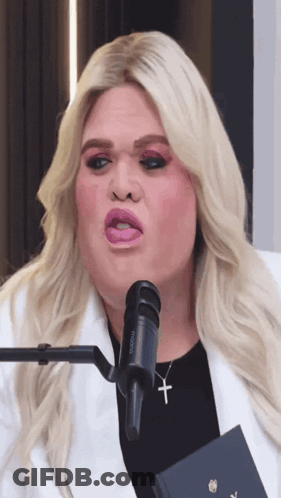 A Woman With A Microphone That Says Rodeon On It GIF