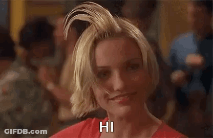 A Woman With A Mohawk On Her Head Is Smiling And Says Hi . GIF