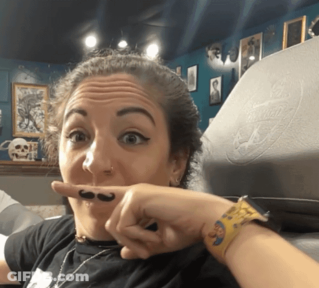 A Woman With A Mustache On Her Finger GIF