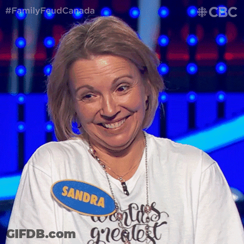 A Woman With A Name Tag That Says Sandra Is Smiling GIF