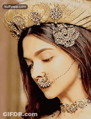 A Woman With A Nose Ring And A Hat On Her Head . GIF