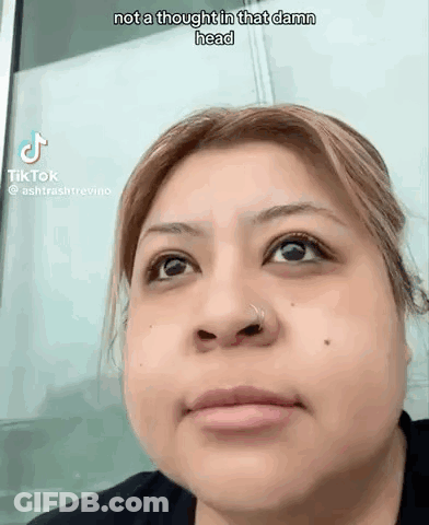 A Woman With A Nose Ring Is Making A Funny Face While Looking Up . GIF