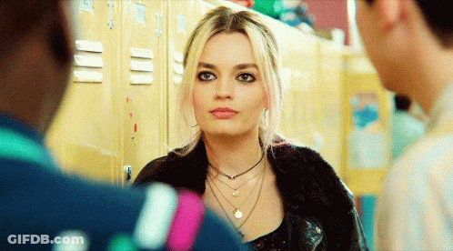 A Woman With A Nose Ring Is Standing In Front Of A Row Of Lockers GIF