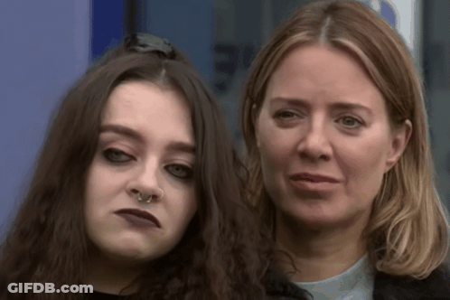 A Woman With A Nose Ring Is Standing Next To A Younger Woman GIF