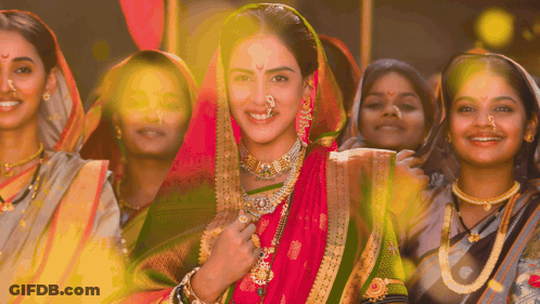 A Woman With A Nose Ring Is Surrounded By A Group Of Women GIF