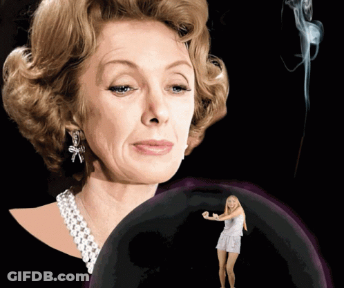 A Woman With A Pearl Necklace And Earrings Stands Next To A Woman In A White Dress GIF